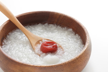 Fototapeta na wymiar Japanese food, Umeboshi and healthy rice congee in wooden bowl
