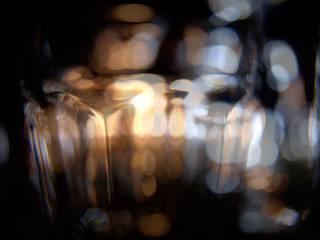 Close ups of wine-, long drink- and spirits-glasses on a wooden shelve in a bar, in front of a dark...