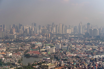 Fototapeta na wymiar Aerial view of Manila skyscrapers through haze and smog