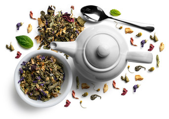 Green tea with natural flavors and a teapot. Top view on white background