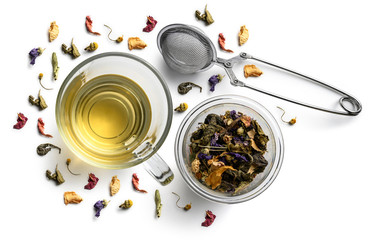 Green tea with natural flavors and a cup. Top view on white background