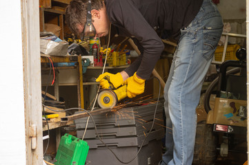 worker using angle grinder