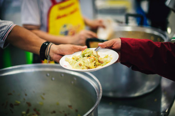 The concept of asking for food with hunger: poor people receive food donated by people in society.