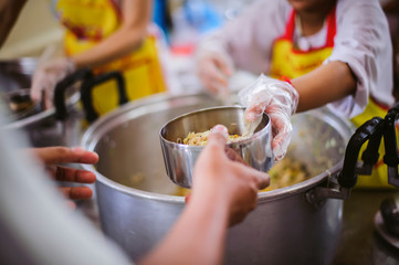 Volunteers provide free food to the underprivileged: sharing food with humans in society