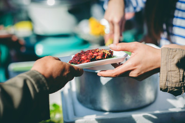 Assisting people with homeless food: Charity: People come to receive free food from volunteers.