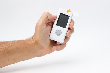 Man holds in hand glucometer measures blood sugar level. Hand holding Blood Glucose Meter