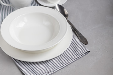 Dining layout. Beautiful serving on a gray linen napkin. A plate for soup or a side dish. Light...