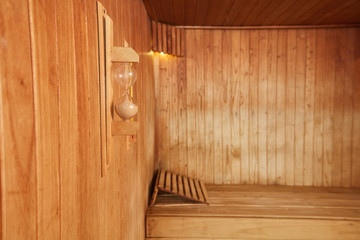 Empty sauna with hourglass in a spa