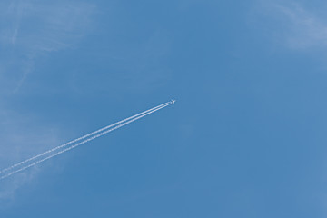  Plane in the sky. Blue background and clouds.