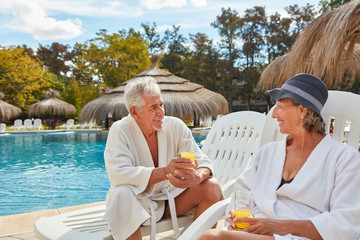 Senior couple in spa hotel by the pool