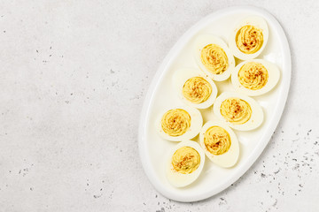 Classic devilled eggs with smoked paprika. Top view, copy space.