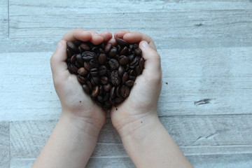 Coffee beans in hands