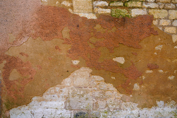 stone red wall with peeling plaster grunge real background for design