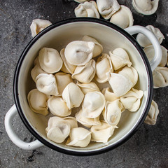 tortellini with filling (ravioli dumplings) menu concept. food background. top view. copy space
