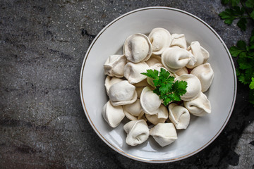 tortellini with filling (ravioli dumplings) menu concept. food background. top view. copy space