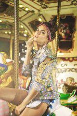 Stylish woman wearing sparkling jacket on the carousel