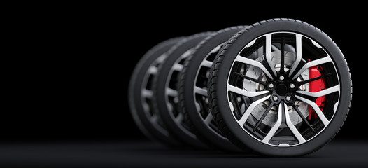 Set of wheels with modern alu rims on black background