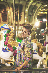 Stylish woman wearing sparkling jacket on the carousel
