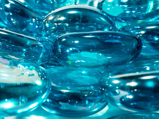 blue translucent glass stones with white  highlights on a white background