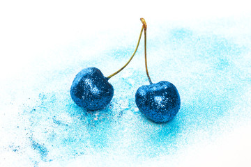 Cherry berries covered with a colorful glitters