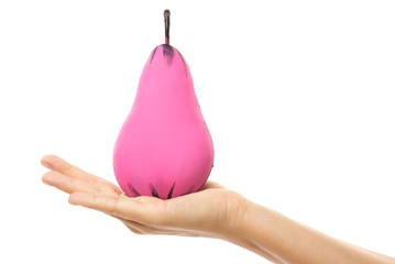 Female hand and creatively decorated pink pear