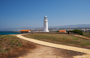 Fototapeta na wymiar Yellow road going to the Paphos lighthouse. Cyprus