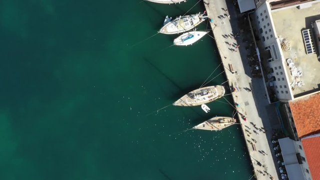 Aerial drone view video of iconic and picturesque Venetian old port of Chania with famous lighthouse and traditional character, Crete island, Greece. Architecture of the Venetian port in Chania.