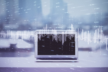 Forex graph hologram on table with computer background. Multi exposure. Concept of financial...