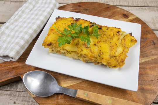 Fish Gratin On A Wooden Table