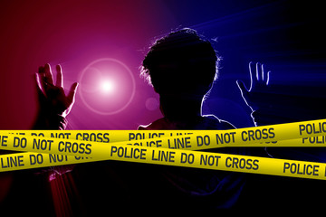 the police line, do not cross tape ribbon with a crime on the background