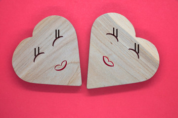 concept of hearts made of wood on a red background
