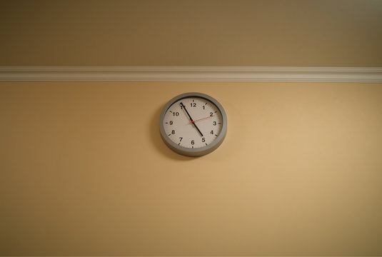 Clock at yellow wall interior background