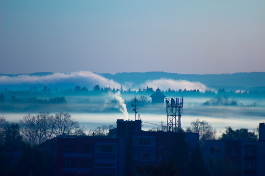 Cold autumn morning in the city. smoke from the chimneys in inversion