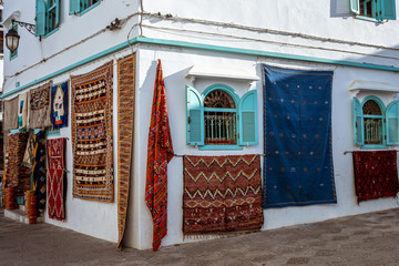 Moroccan  carpets in the street shop souk of Asilah, Morocco