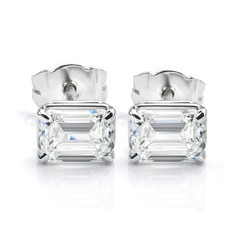 Pair of Emerald Cut Diamond Solitaire Stud Earrings Isolated on White Background