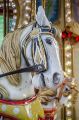 Fototapeta na wymiar Novi Sad, Serbia - December 13. 2019: Downtown Novi Sad. The decorations on the children's carousel with wooden horses