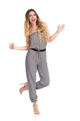 Happy Young Woman In Jumpsuit Is Dancing And Shouting
