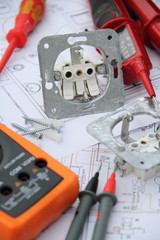Sockets with a screwdriver and a measuring device on a circuit diagram