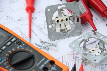 Sockets with a screwdriver and a measuring device on a circuit diagram