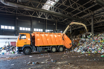 truck throws garbage at sorting modern waste recycling processing plant. Separate and sorting...