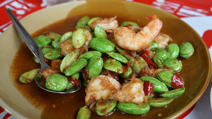 Spicy stir fried smelly bean with fresh shrimp on brown plate