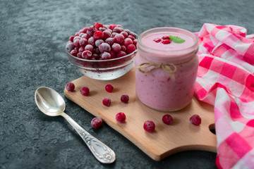 Frozen cranberry yogurt on a black background. The concept of healthy desserts.