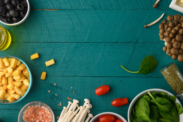 Flat lay, Ingredients for salad or for a healthy diet. Vegetarian food. With space for design on green wooden texture.