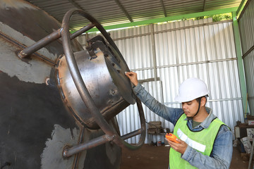 Mechanic engineer  in factory checking quality of metals