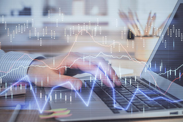 Double exposure of stock market graph with man working on laptop on background. Concept of financial analysis.