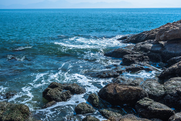 Fototapeta na wymiar Sea waves splash on stones