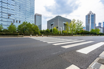 Fototapeta premium empty road with zebra crossing and skyscrapers in modern city.