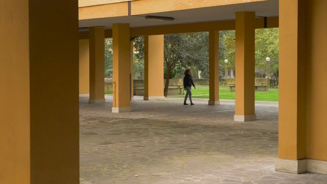 young woman walking disappears and reappears in different site - pacman effect
