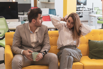 Man in suit and beauty woman sitting and working on phone