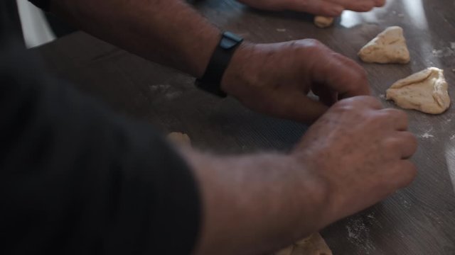 Baker Rolling Freshly Made Dough On Kitchen Table. Slow Motion